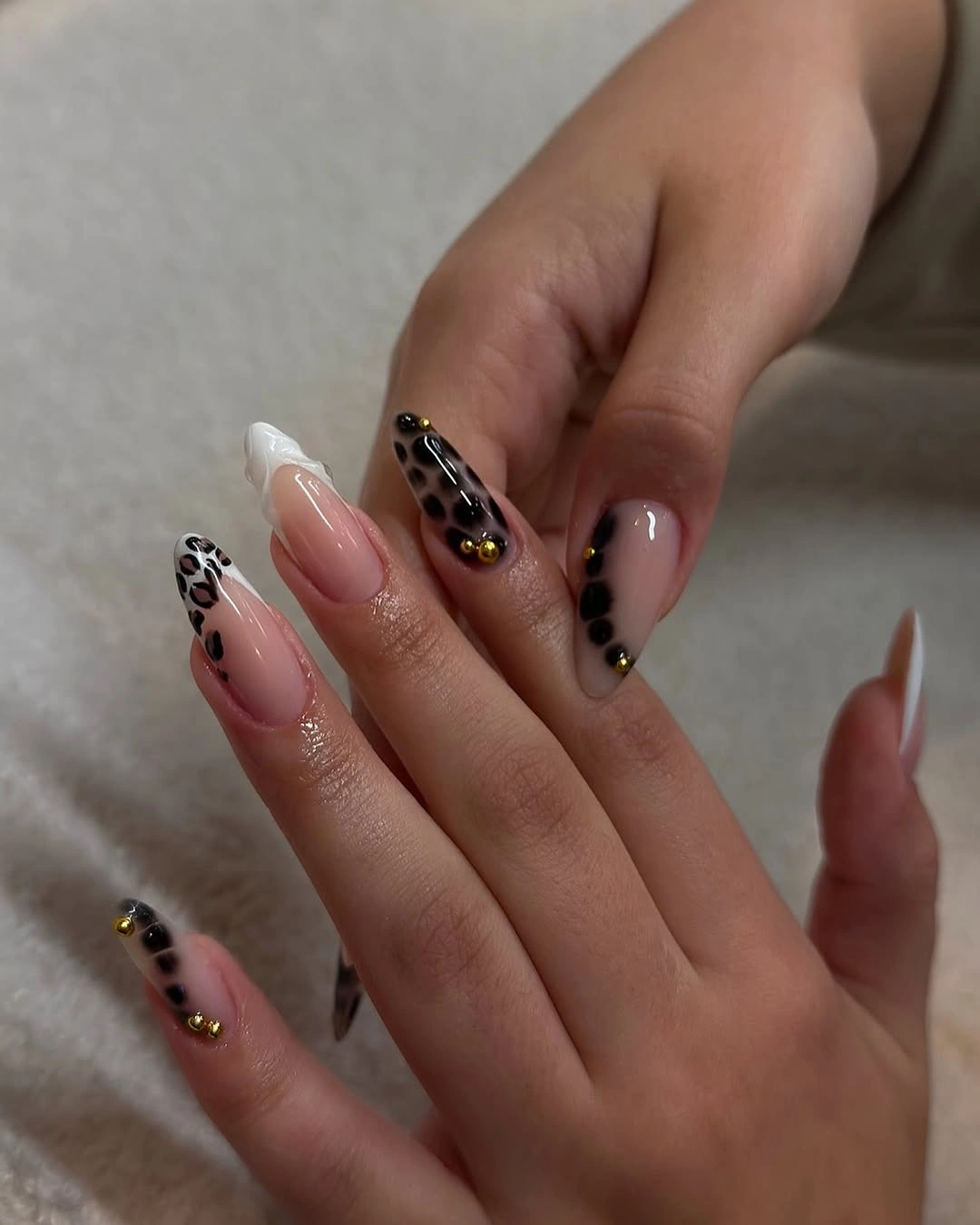 Nude nails with black gold and spotted accent details