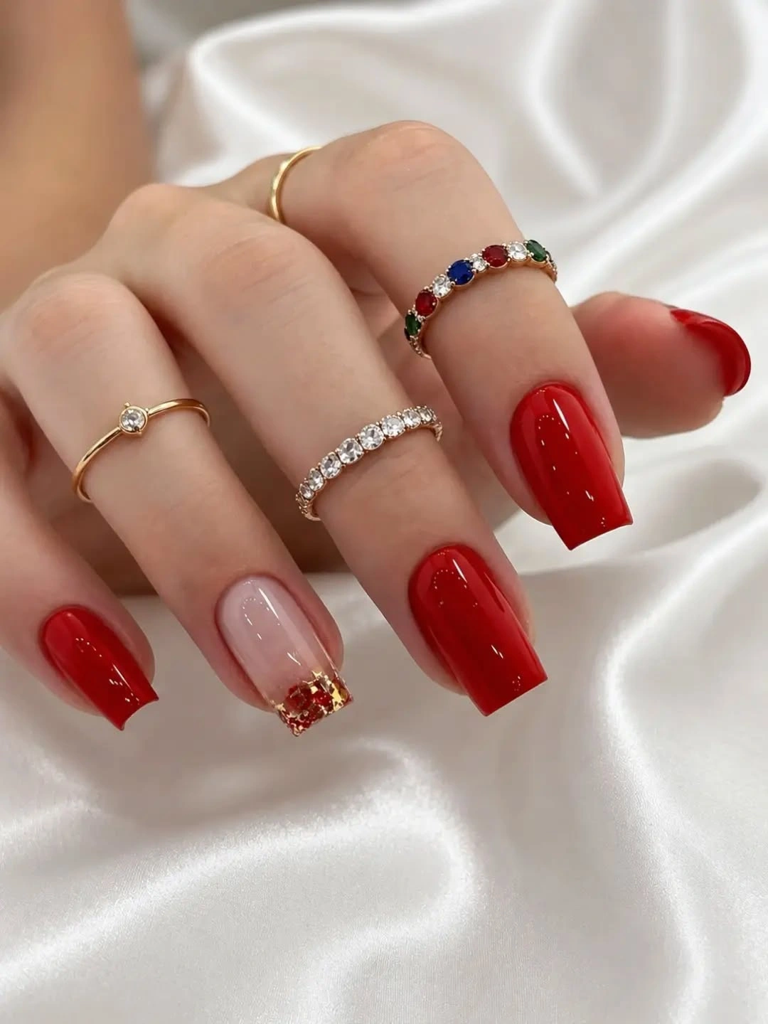 Medium square red nude nails with small gold accents