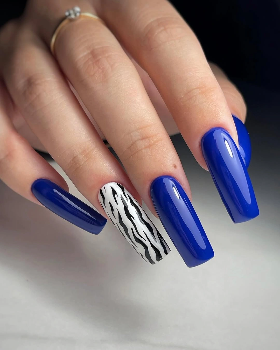 Long cobalt nails with one black and white zebra accent