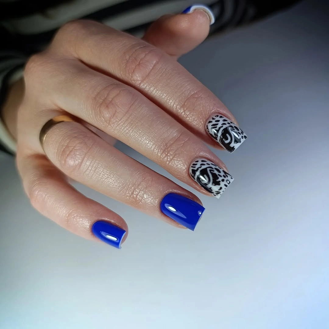 White almond nails with tiny orange illustrated accents