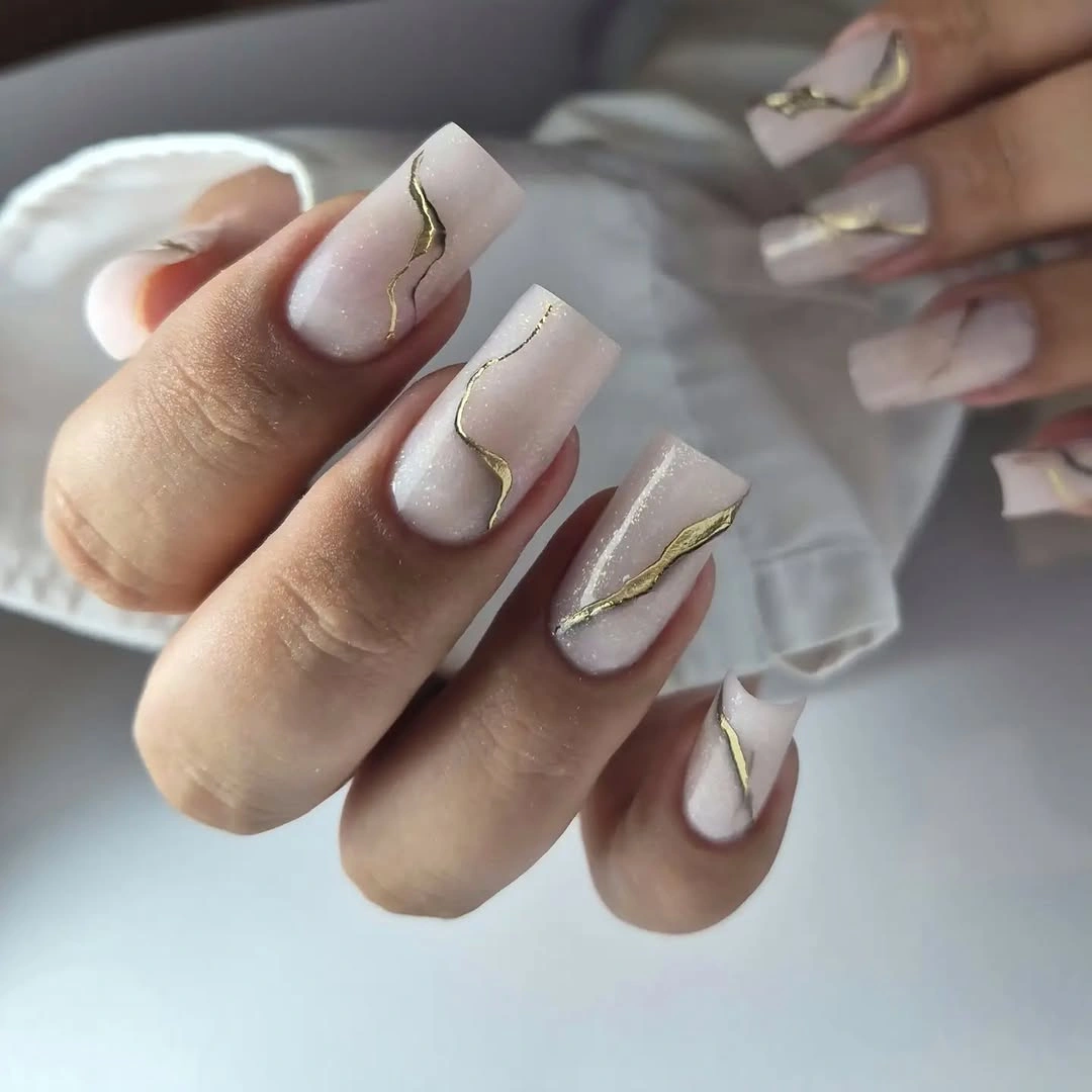 Pale almond nails with clustered white rounded accents
