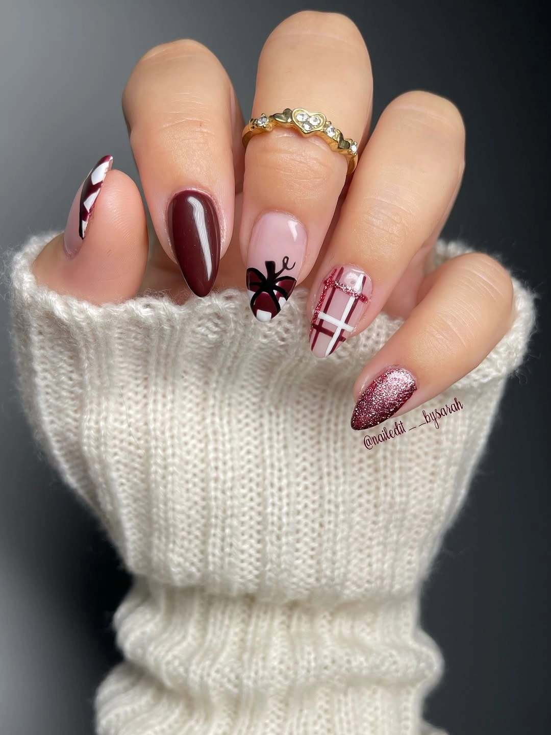 Burgundy almond nails with blush plaid and glitter accents