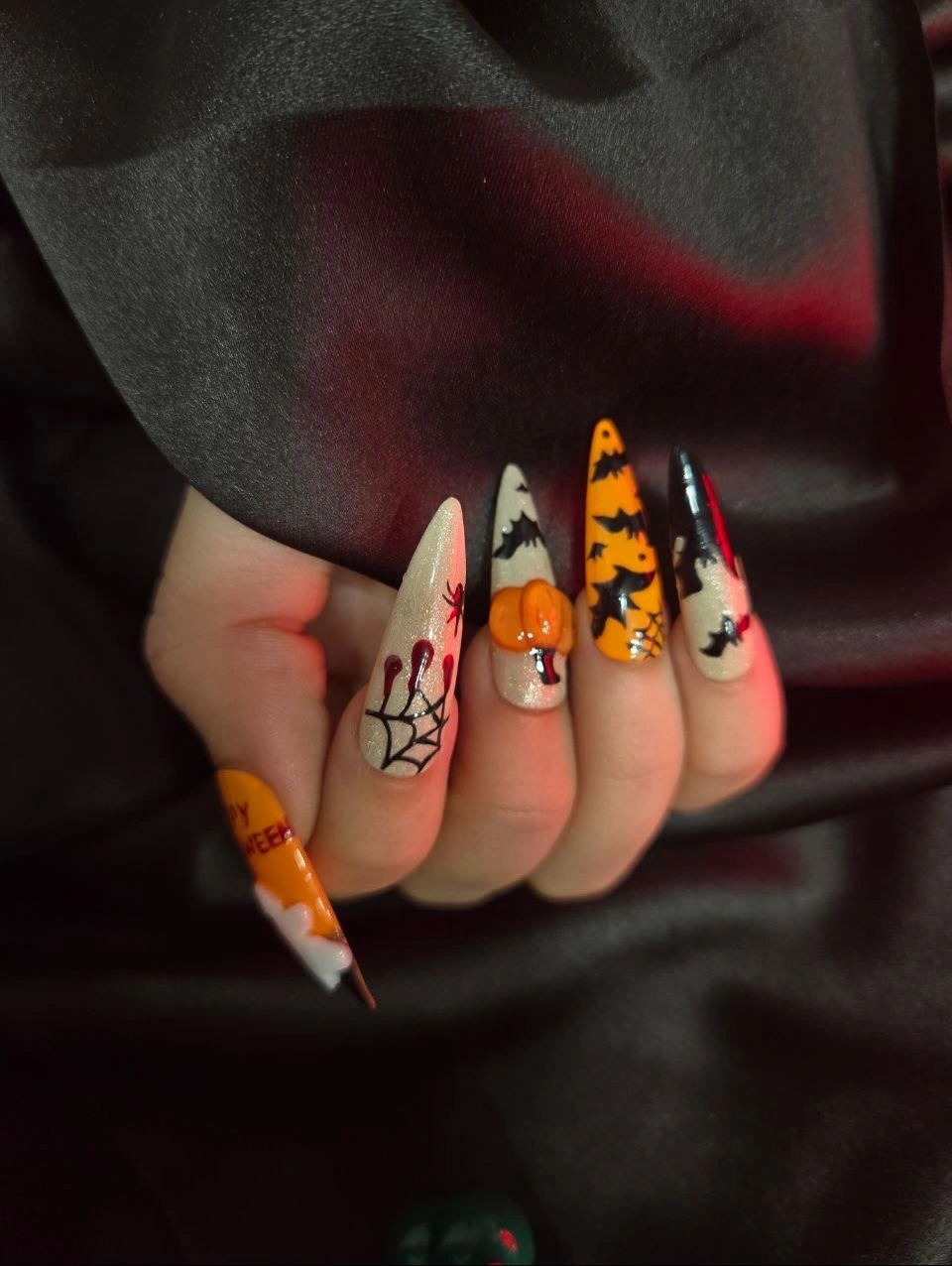 Very long stiletto nails with black orange Halloween patchwork