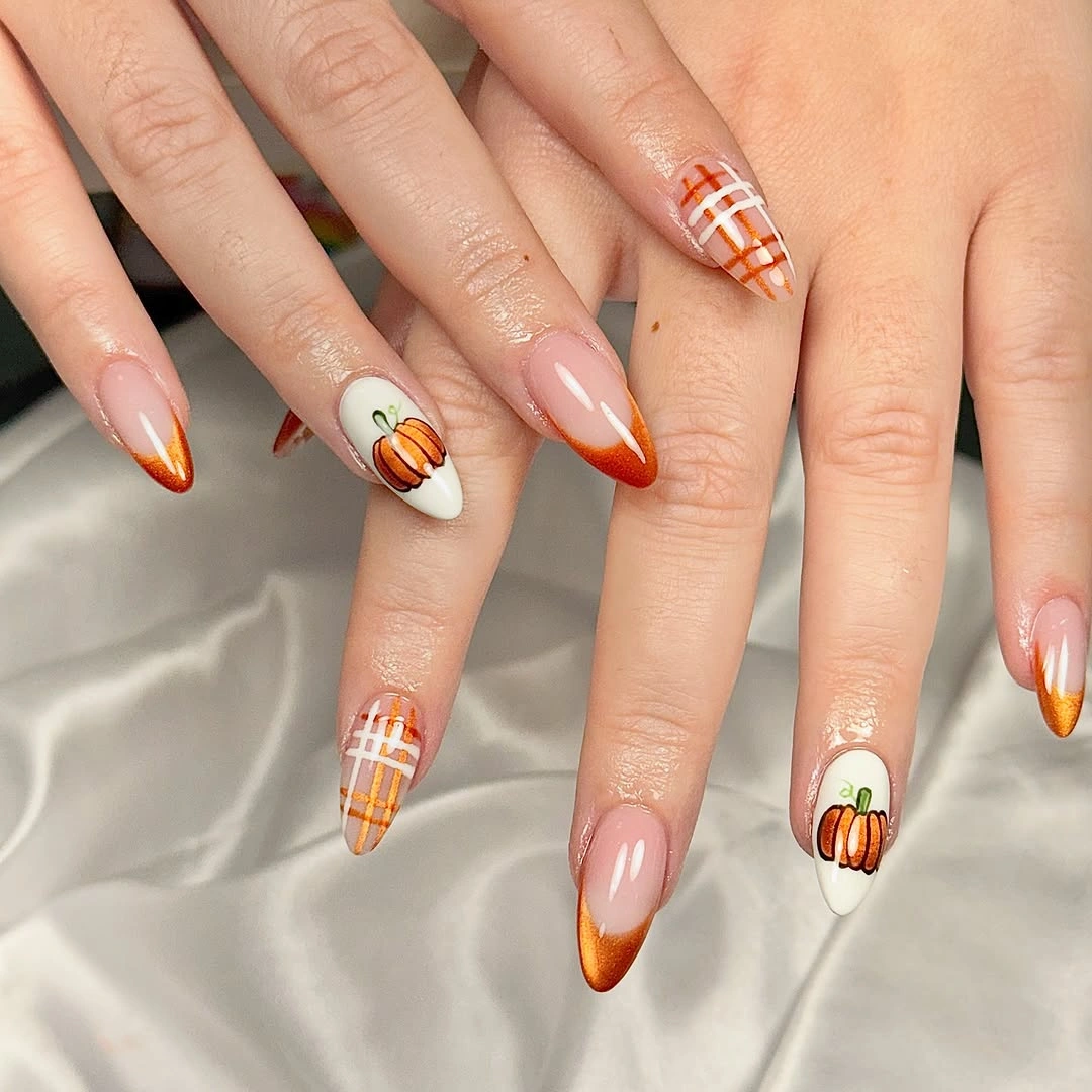Almond nails with orange edges plaid and pumpkin accents