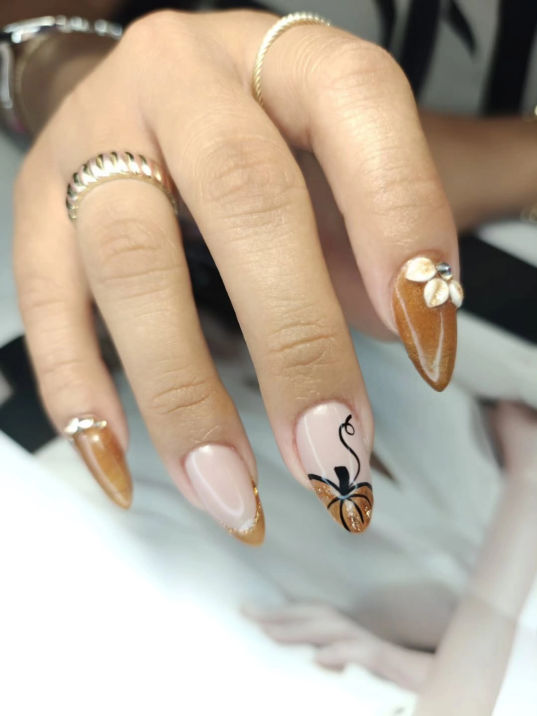 Medium almond nails with warm brown metallic tips
