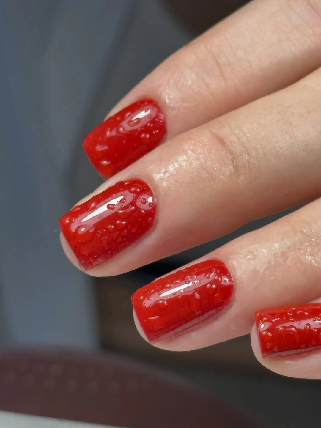 Wet look red nails with raised texture