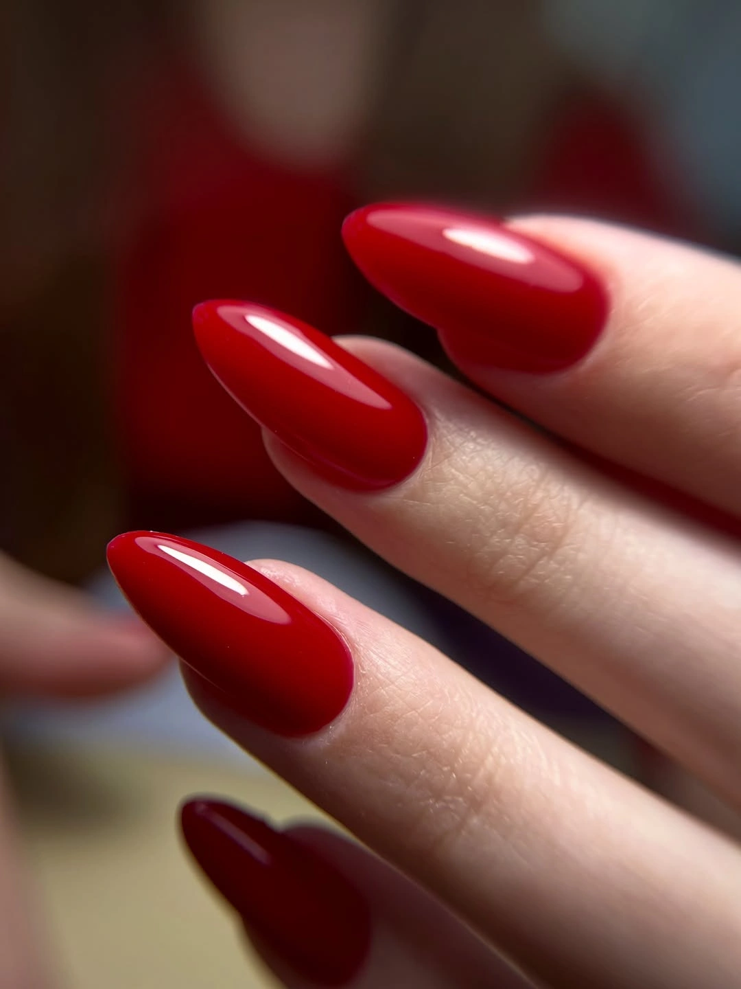 Sleek glossy red almond nails