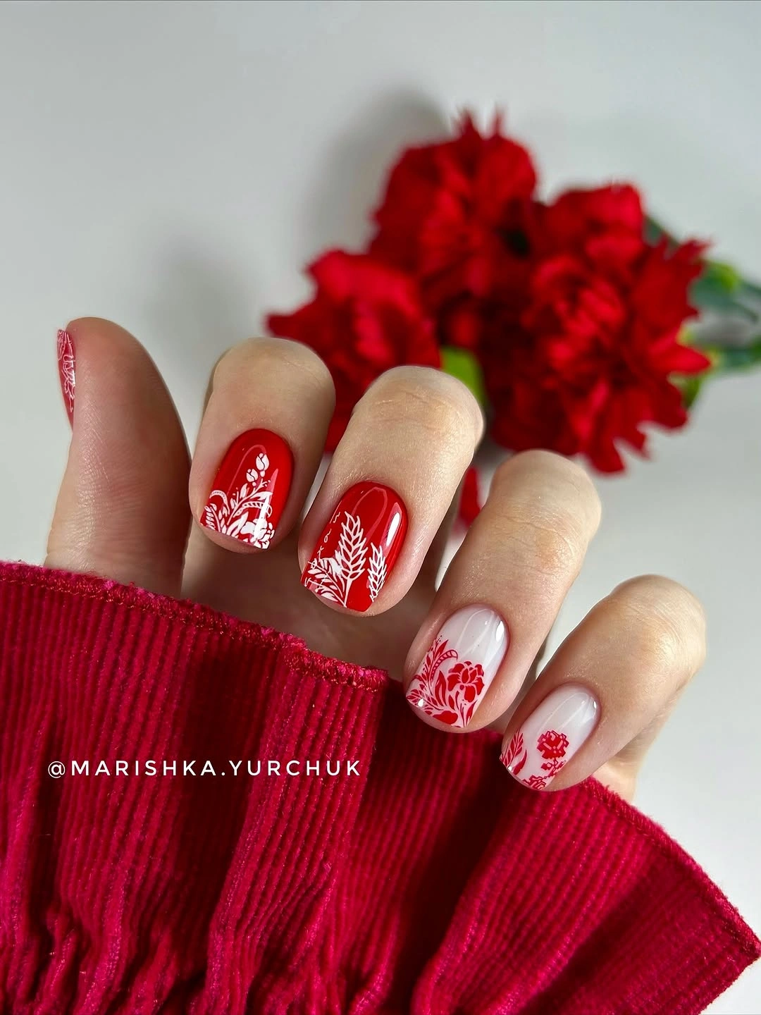 Short red nails with white botanical art