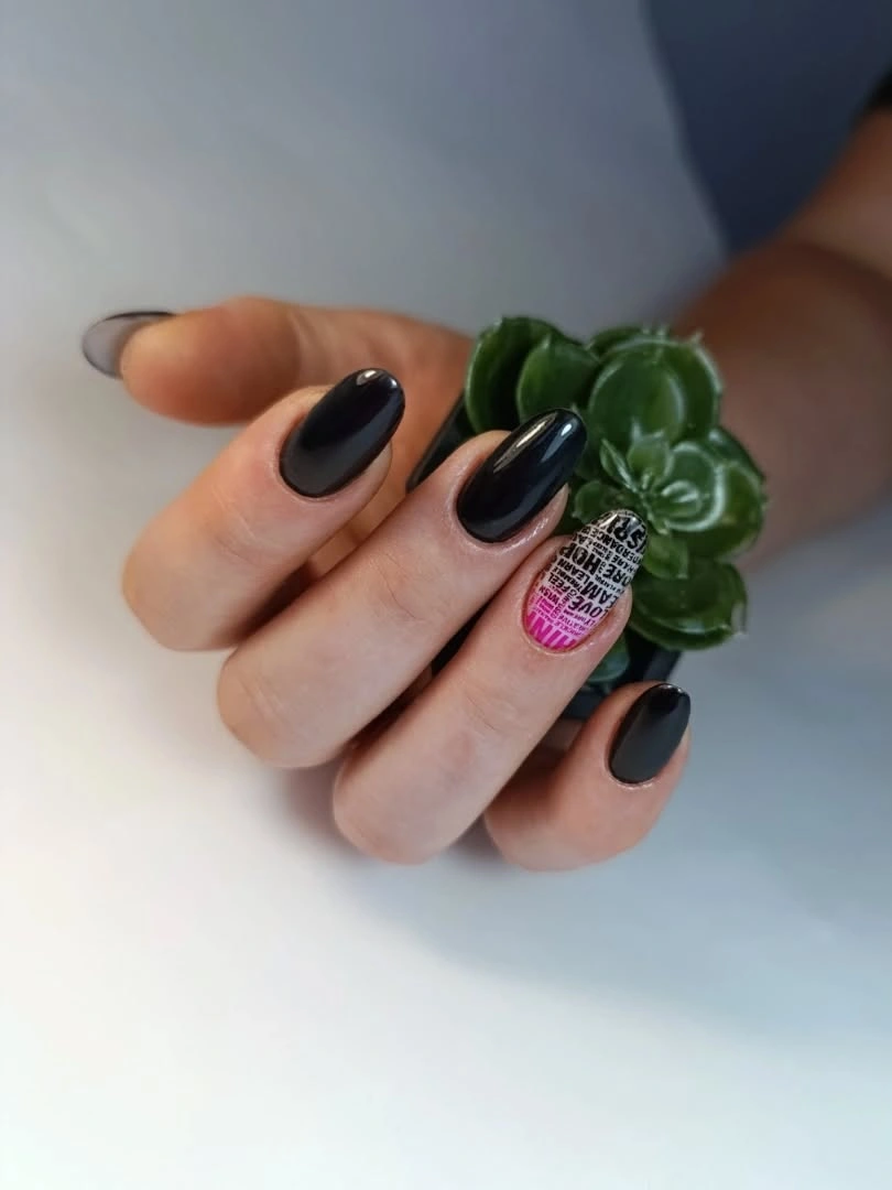 Glossy black almond nails with one purple green accent