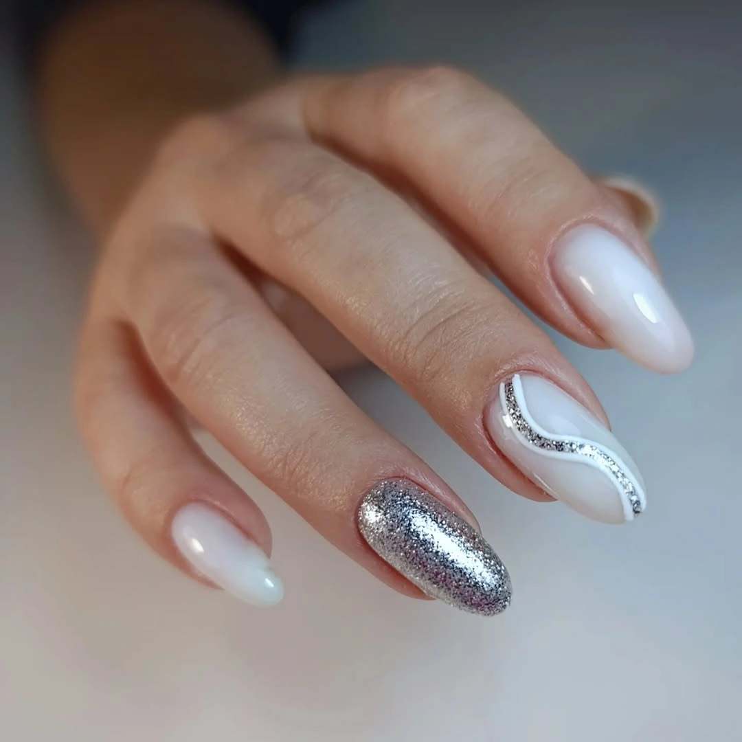 Milky white almond nails with slim silver accents