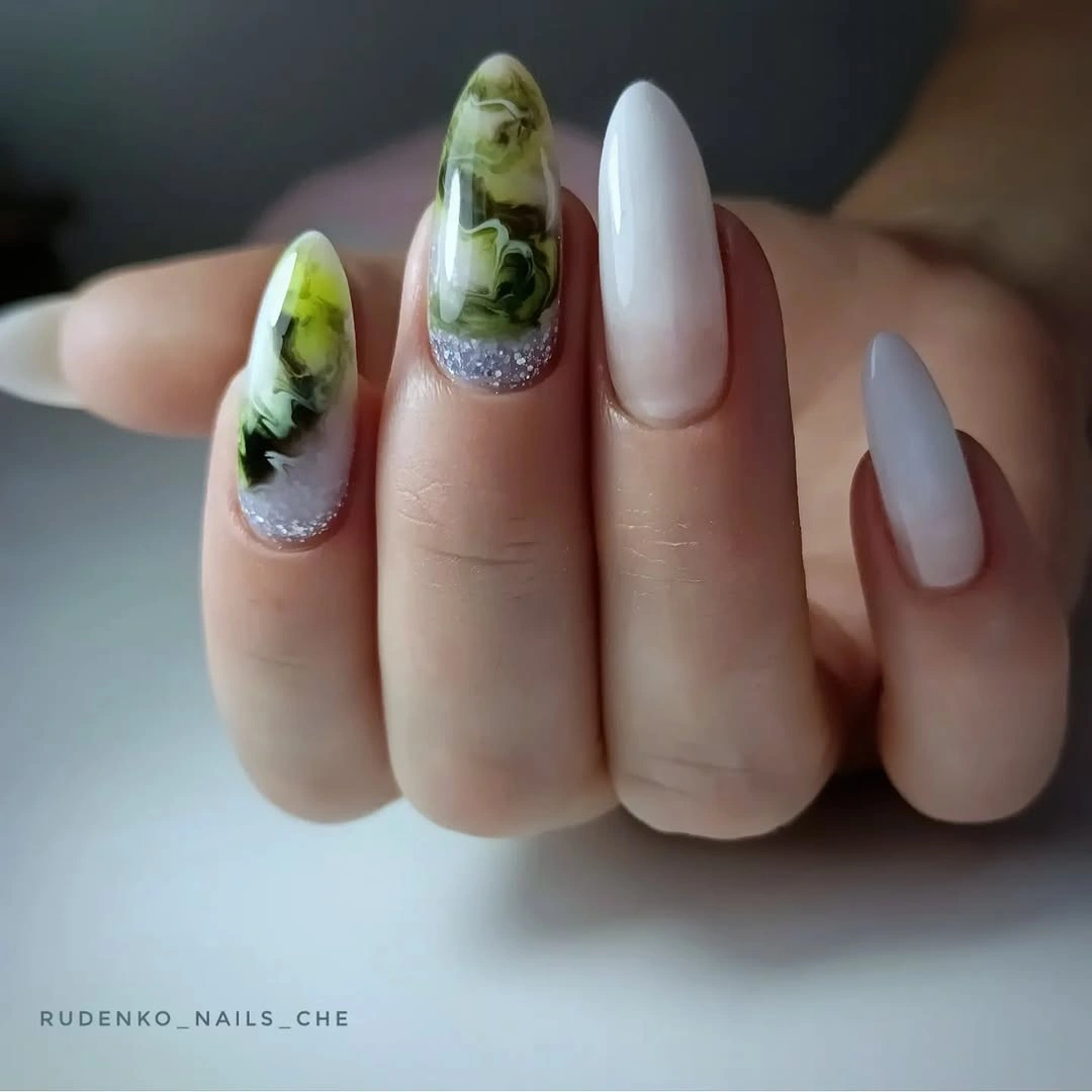 White almond nails with green illustrated accent details