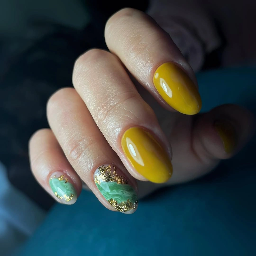 Mustard almond nails with green gold reflective accents