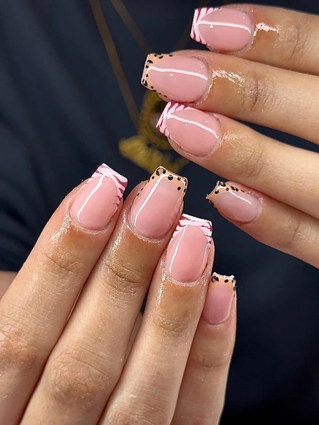 Short pale pink square nails with fine black curved outlines