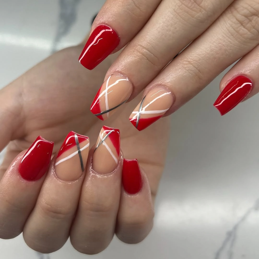 Short red coffin nails with nude geometric negative space