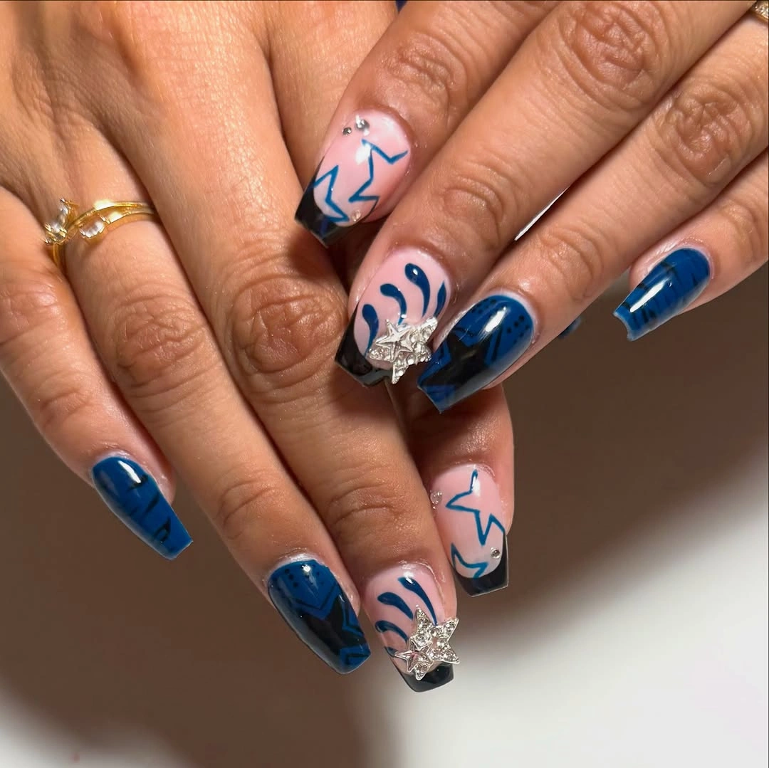 Short blue nails with playful white illustrated accents