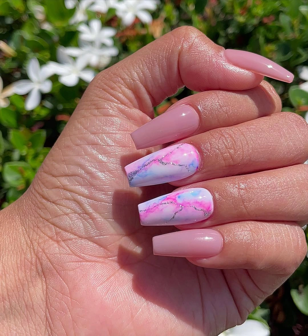 Short dusty pink coffin nails with two colorful marble accents