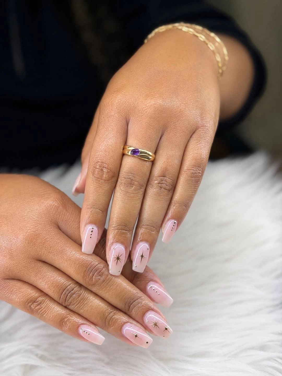 Short pale pink coffin nails with tiny dark dot accents