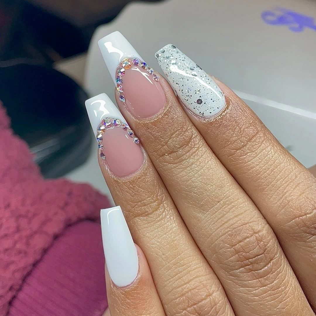 Short pink coffin nails with angled white tips and silver glitter