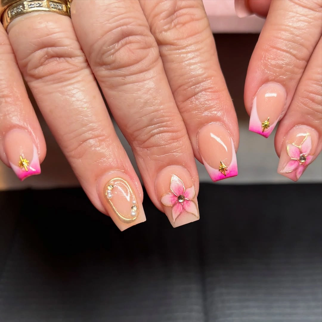 Short blush coffin nails with tiny pink flowers and warm dots