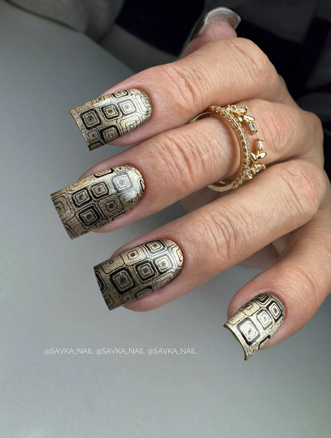 Medium square cream nails with black gold geometry
