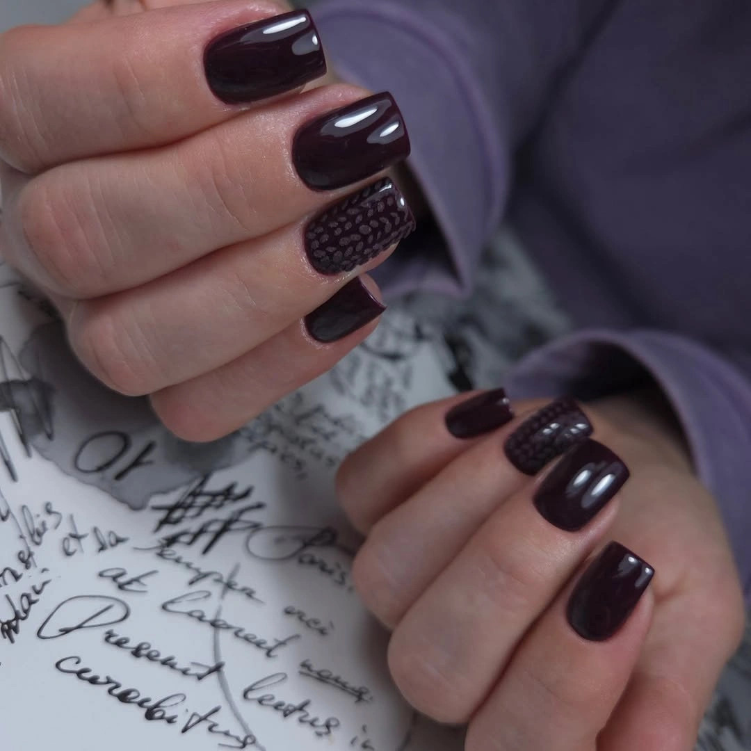 Short deep plum square nails with textured accent