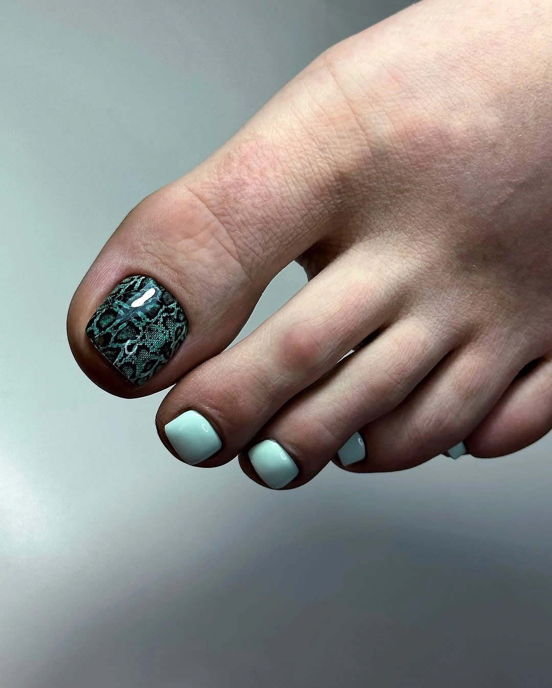 Dark green patterned big toes with pale mint and white square accents