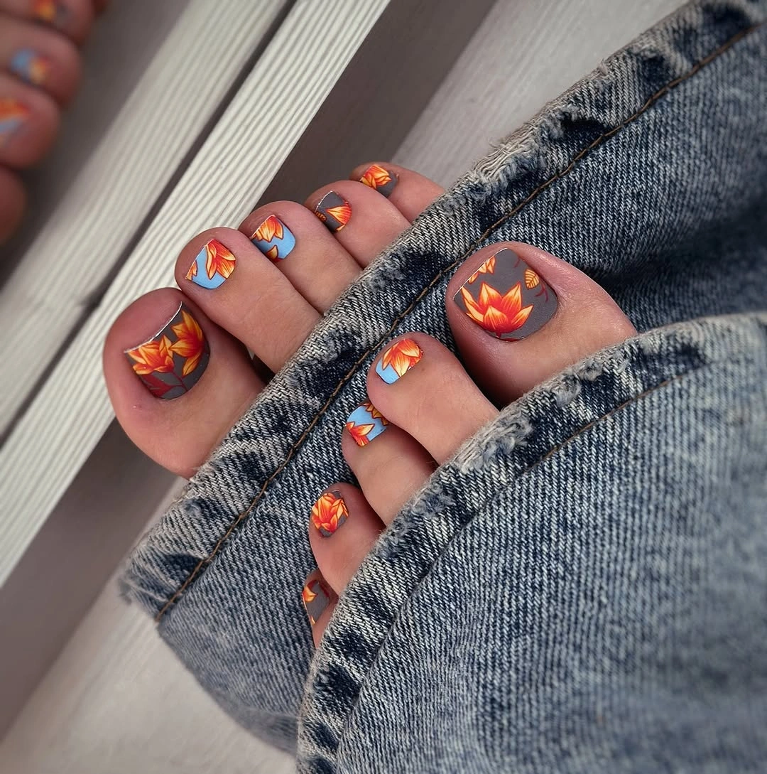 Short square orange toes with small rust and leaf-like accents