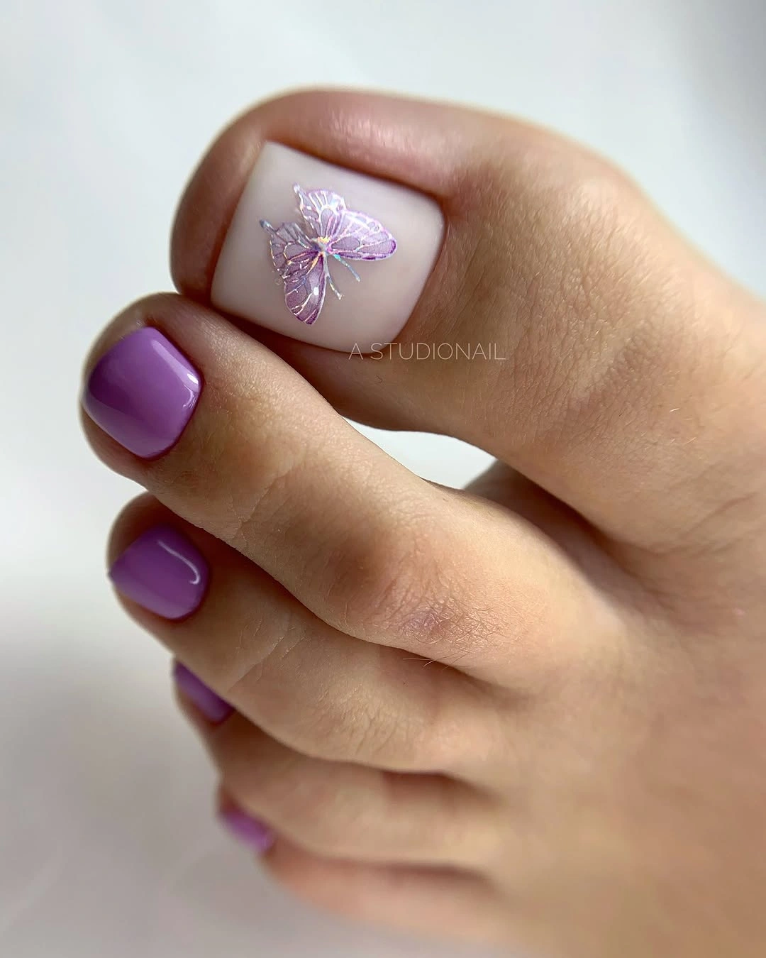 Purple and lilac short square toes with a small floral accent