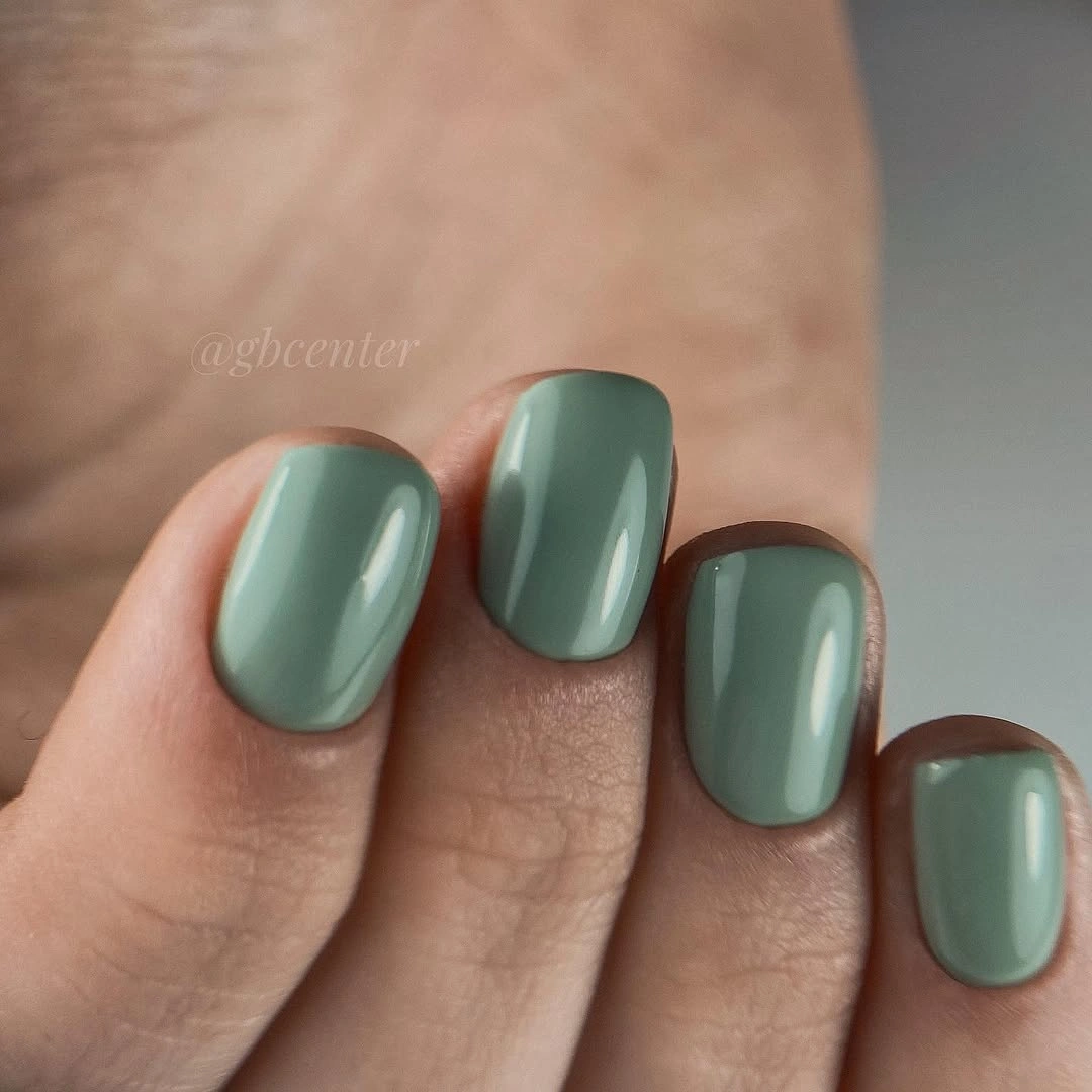 Short muted sage green nails with glossy square edges