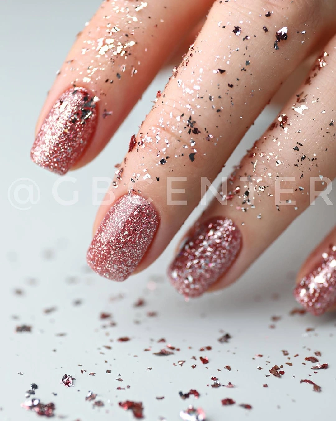 Short rose-pink glitter square nails with scattered reflective flakes