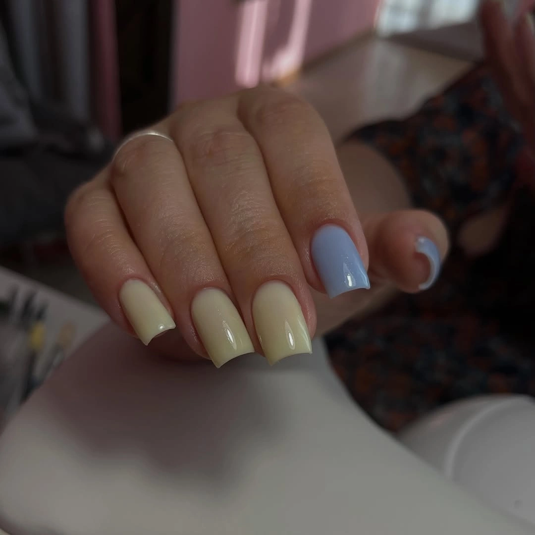 Short pale yellow square nails with glossy clean coverage