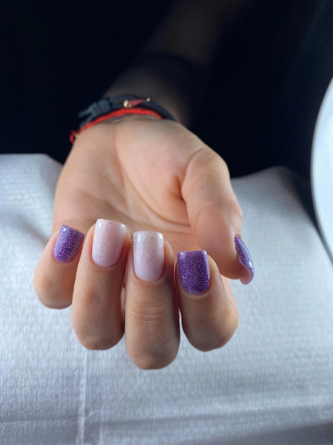 Short lavender square nails with selected purple glitter accents