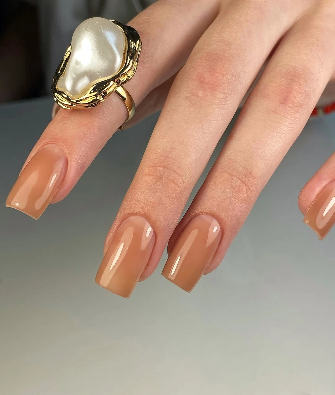Medium almond nails in glossy caramel nude