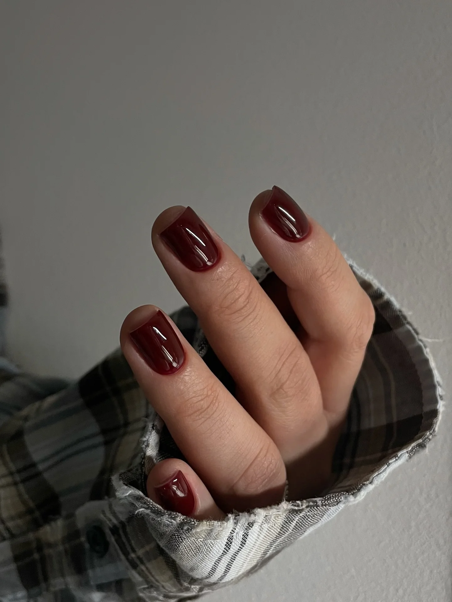 Short glossy dark cherry nails with rounded square tips
