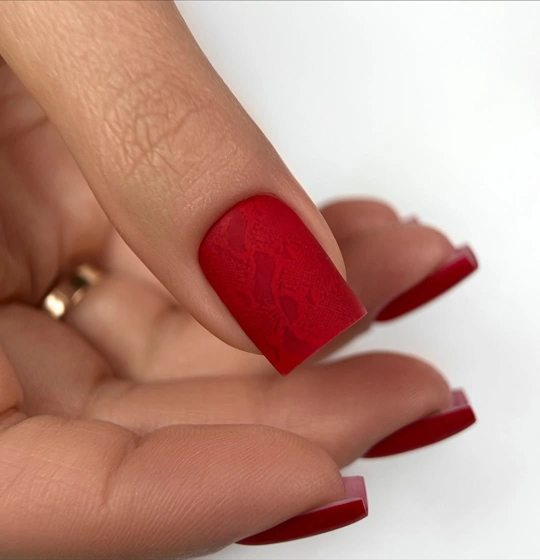 Short red square nails with subtle tonal texture