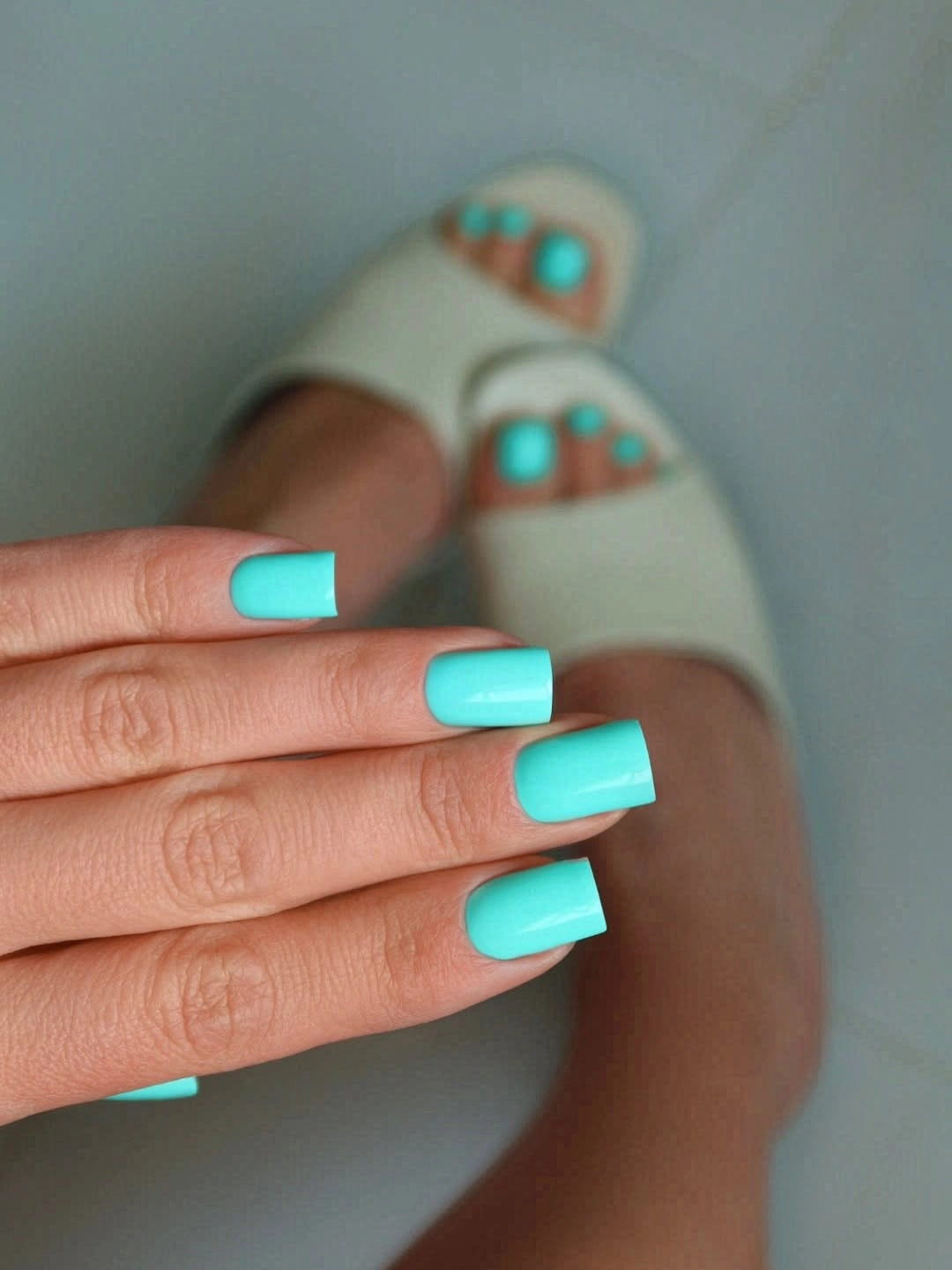 Short glossy turquoise square nails with a cool vivid finish