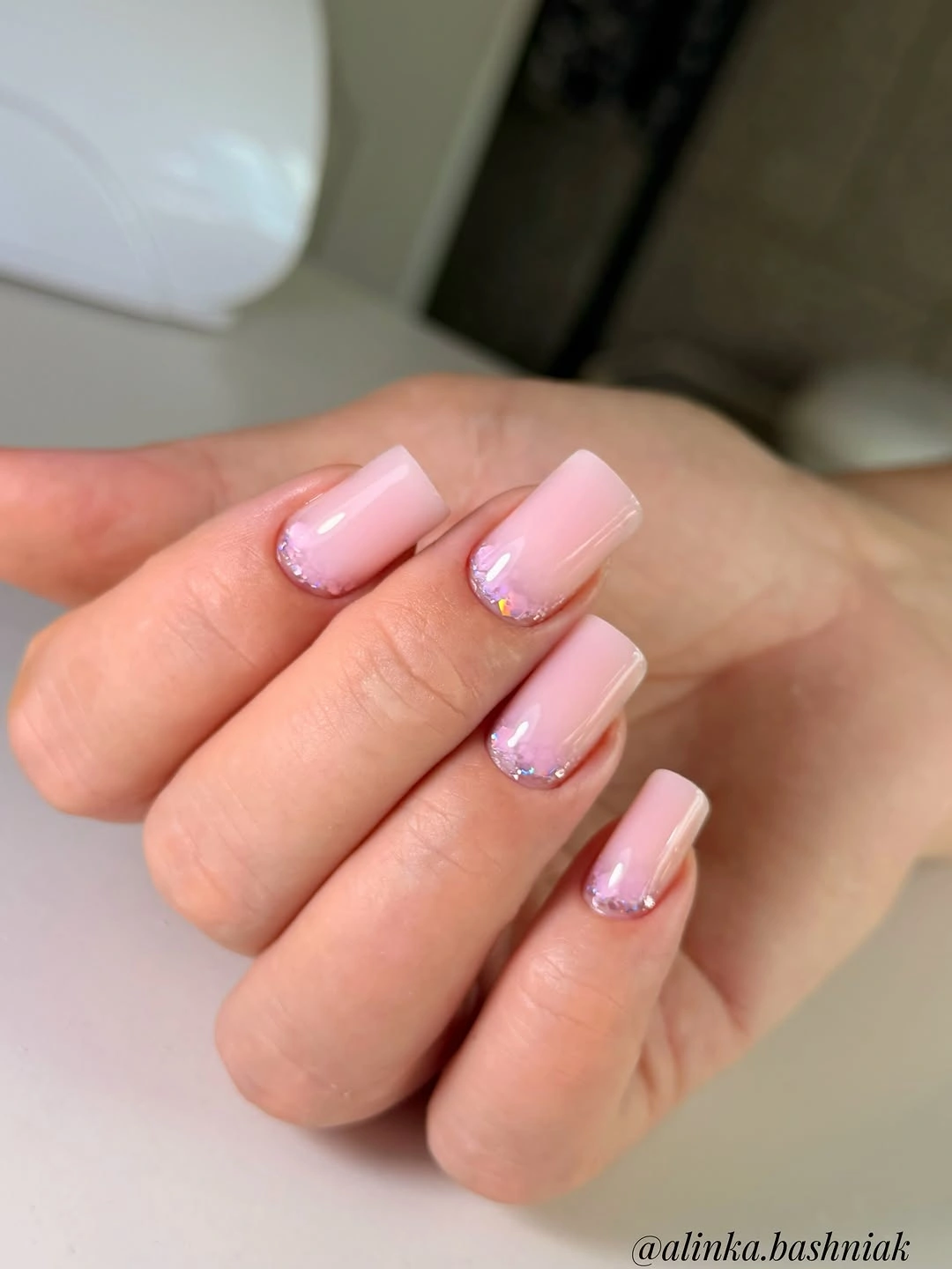 Baby pink nails with reverse glitter cuticles