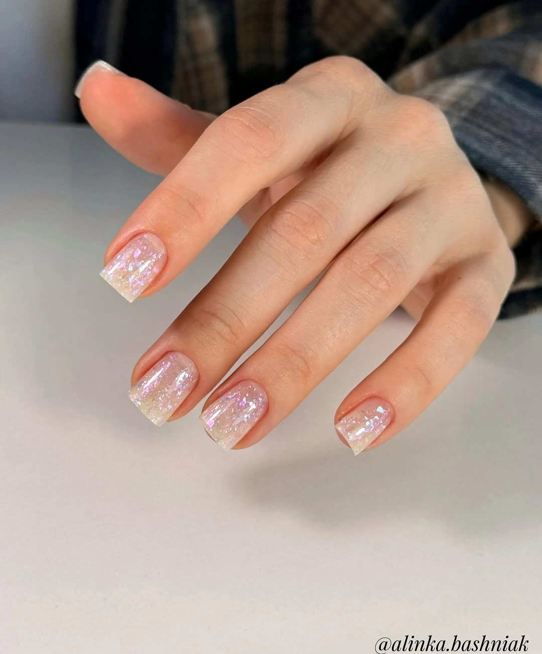 Short sheer pink nails with iridescent sparkle