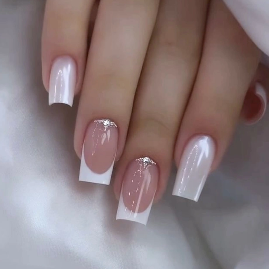 Pearly white French nails with cuticle sparkle