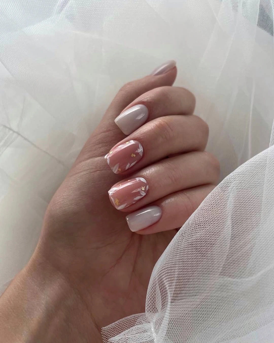Milky white nails with blush floral accents