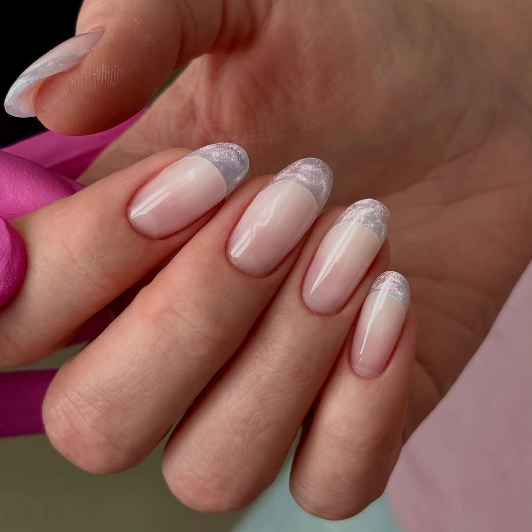 Frosted silver French tips on nude almond nails