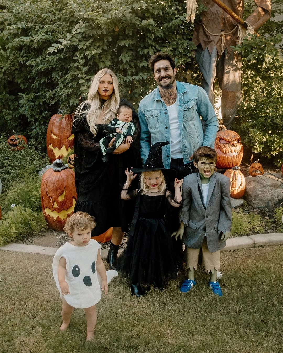 Family witchy Halloween outfits with black dresses gray layers and pumpkins