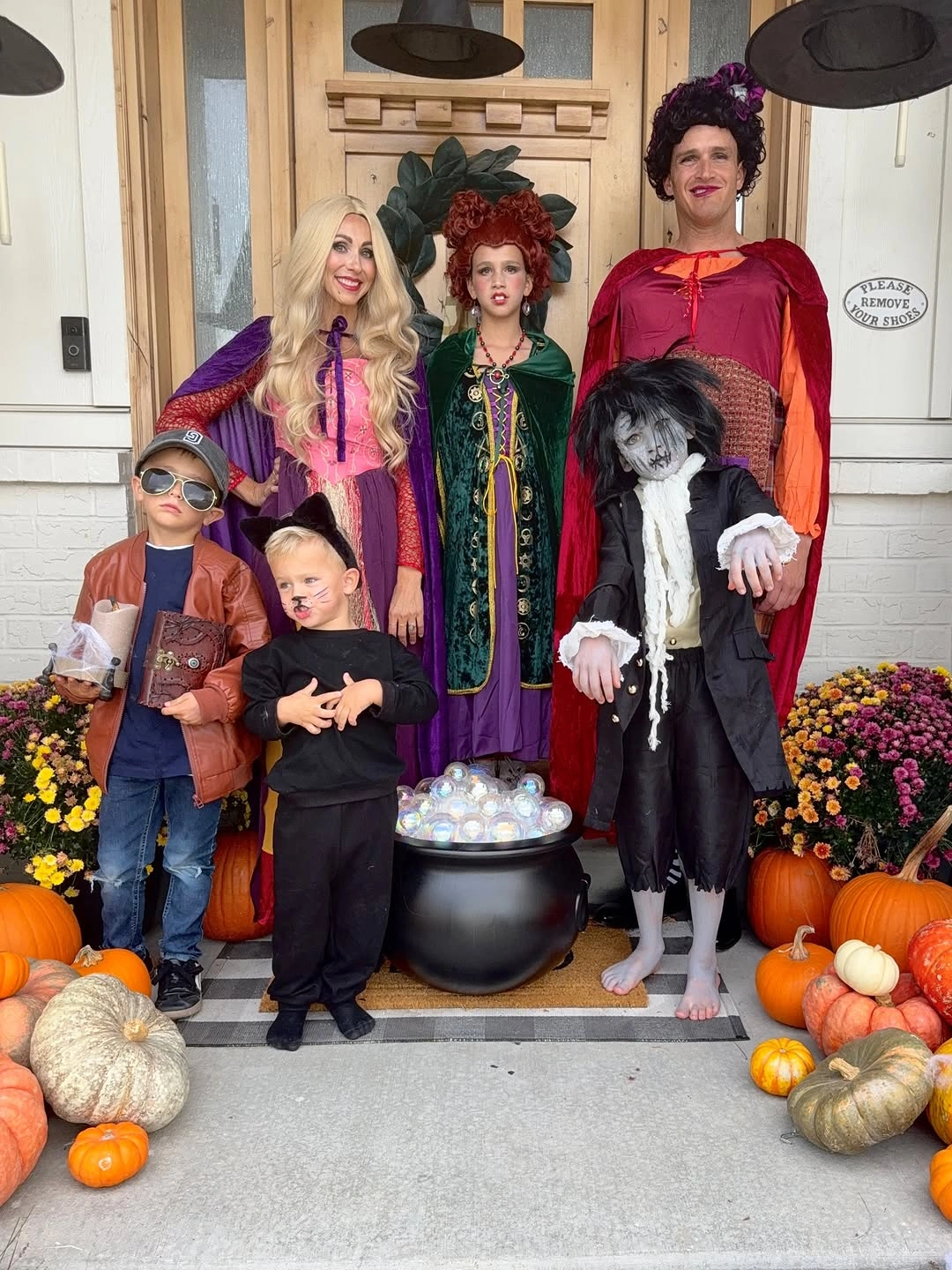 Family Halloween costumes with storybook capes hats and pumpkins