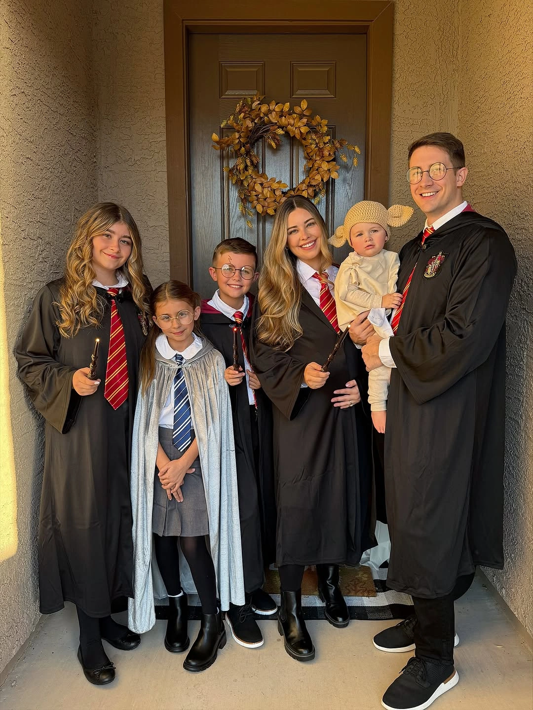 Family costumes with black academic robes and striped tie details