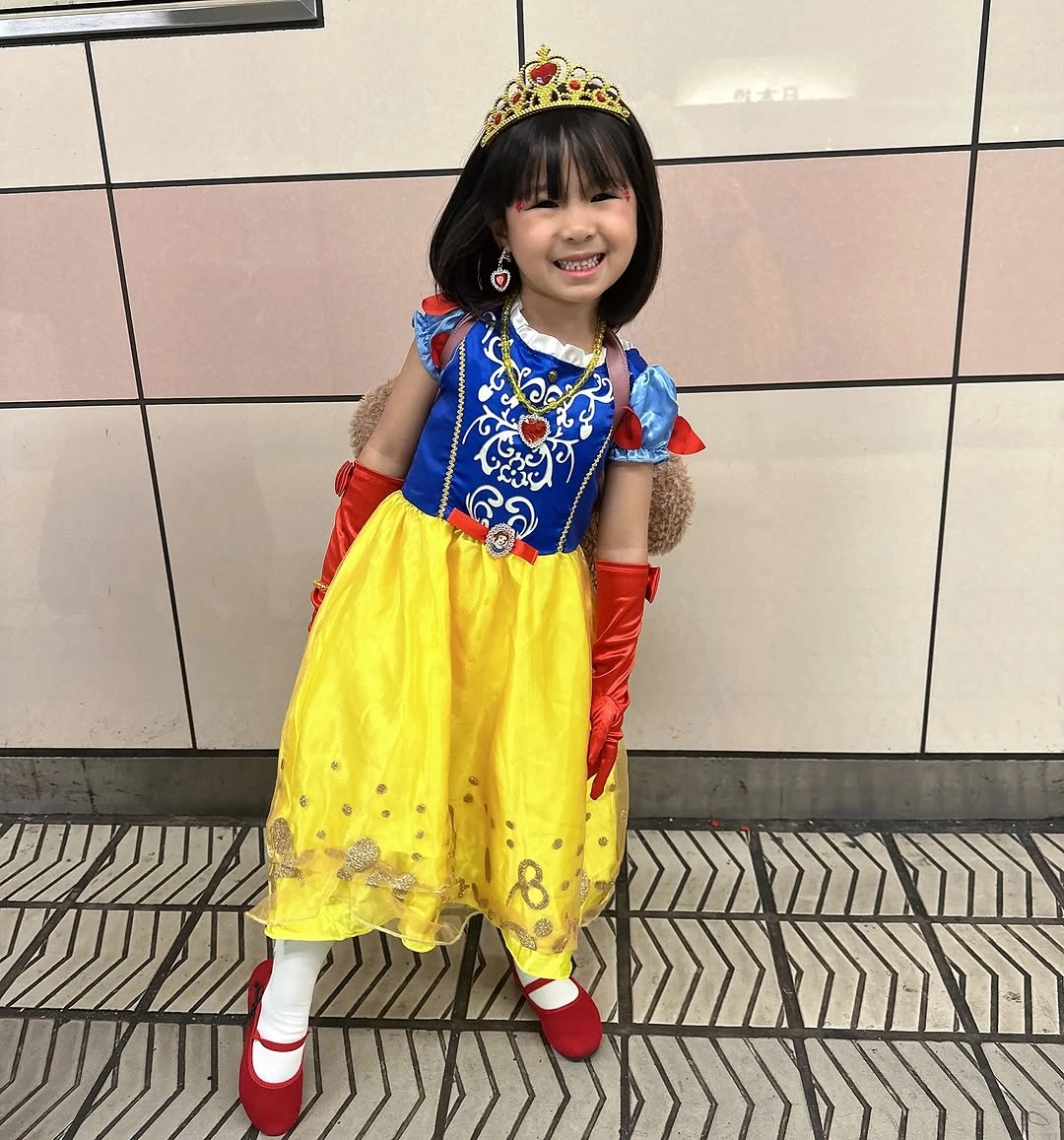 Girl fairytale costume with blue bodice yellow skirt red gloves and crown