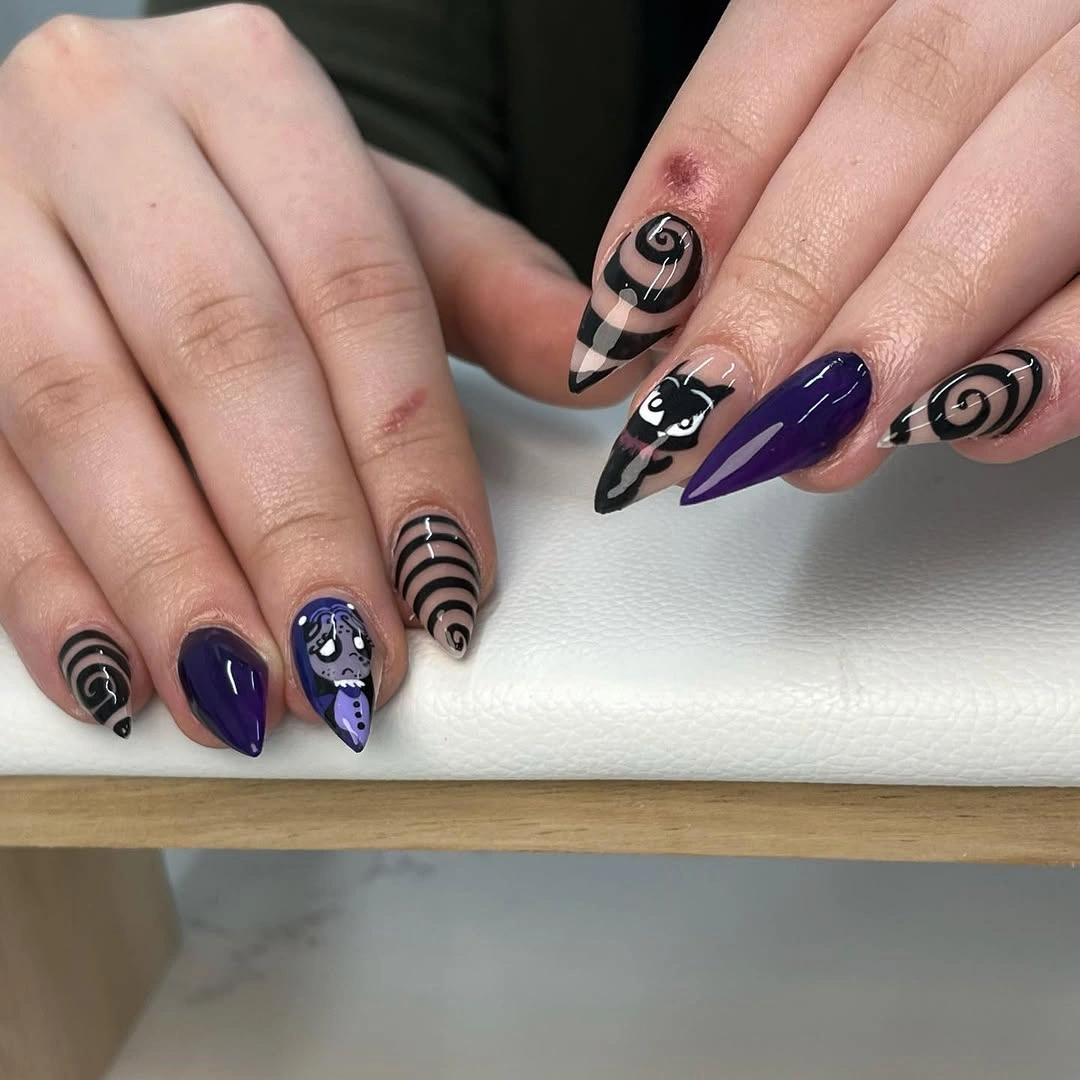 Purple almond nails with black spirals moons stars and ghost detail