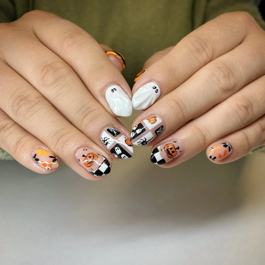 Short rounded nails with pumpkins ghosts and black checkerboard