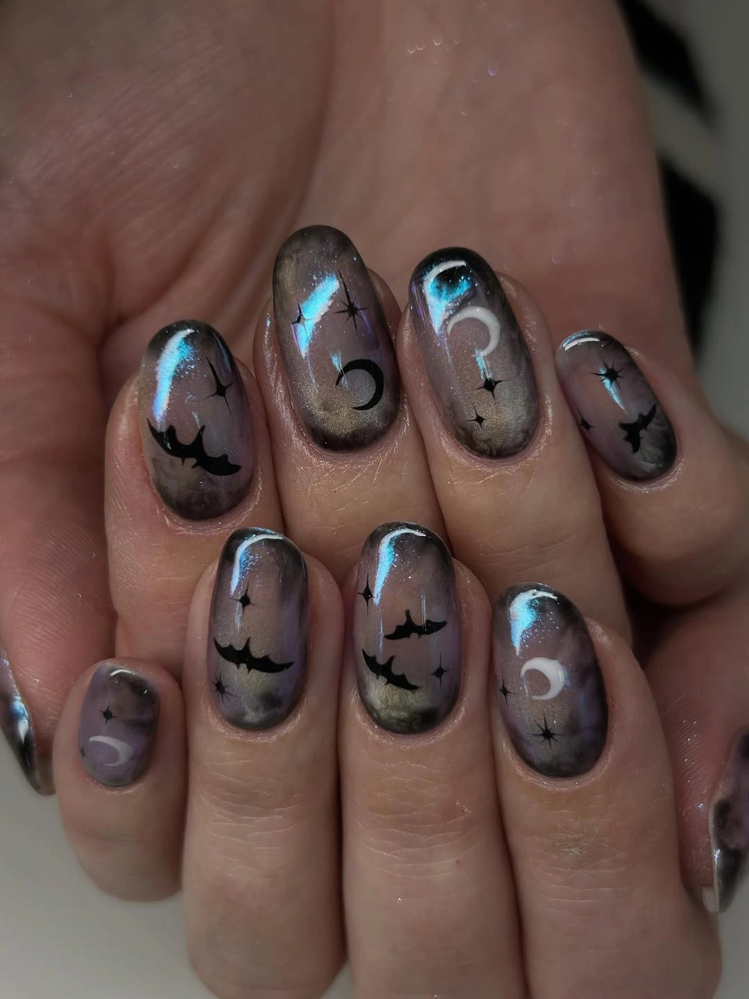 Short gray nails with blue highlights bats and moons