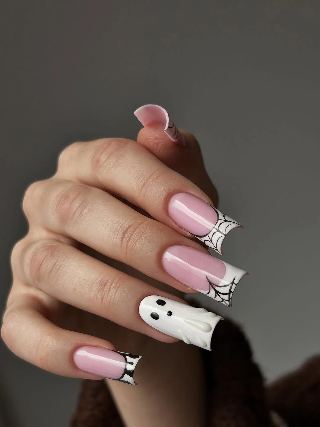 Long pink square nails with corner webs and white ghosts
