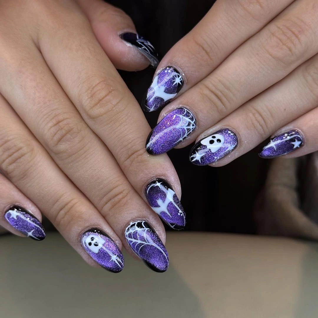 Purple shimmer almond nails with white ghosts and webs